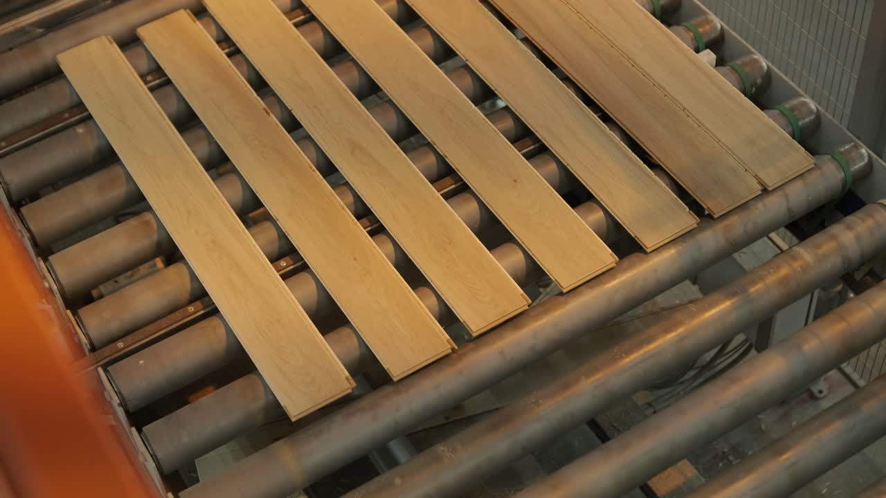 Wooden Planks Moving on an Automated Roller Conveyor Belt in a Factory