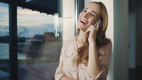 business woman talking phone in luxury house. relaxed woman speaking cellphone.