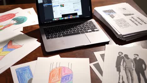 a creative workspace featuring a laptop surrounded by colorful drawings and design sketches, blending art and technology in an inviting artistic atmosphere