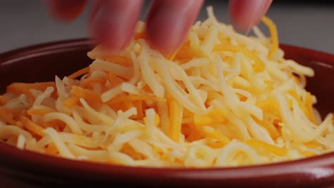 some different sorts of grate cheese on plate close up macro. chef grating cheese mozzarella, cheddar for meals. itallian food, pizza, pasta. high quality 4k footage