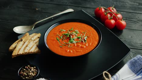 tomato soup in bowl with crisp bread