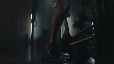 person working out on an air bike in a gym