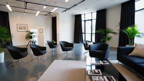 modern and elegant lounge with black furniture and large windows