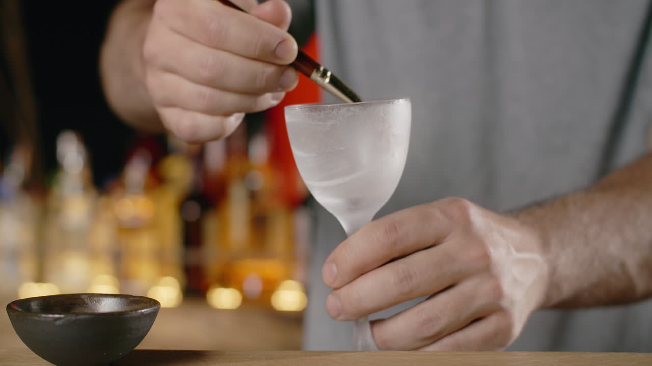 Bartender preparing a cocktail with a brush