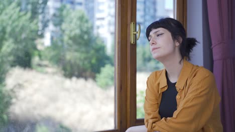 thoughtful and unhappy young woman at home.