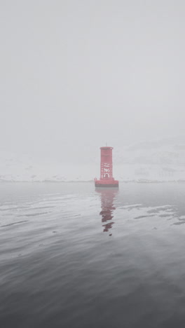 red buoy in foggy water