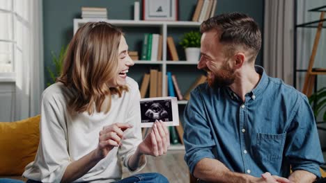 happy couple looking at ultrasound picture