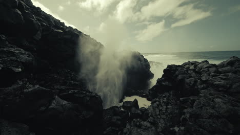 powerful waves crashing through a blowhole