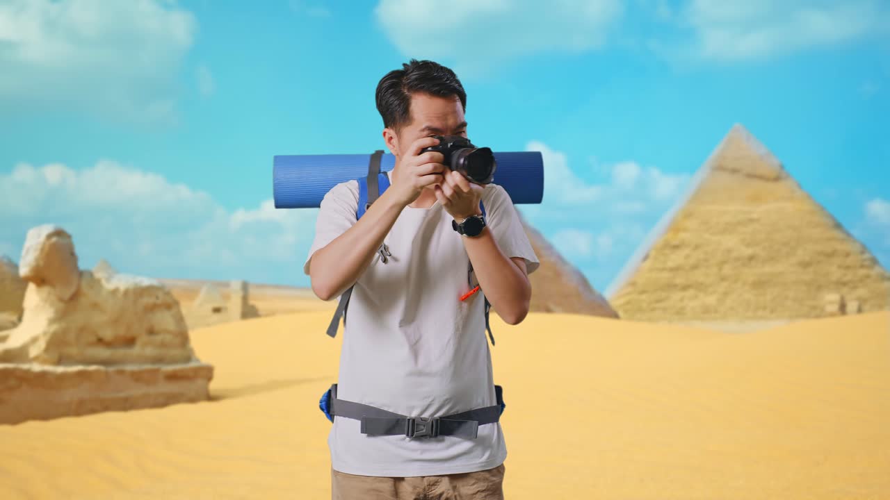 Asian Male Hiker With Mountaineering Backpack Using A Camera Taking Picture While Traveling In Pyramid Of Giza