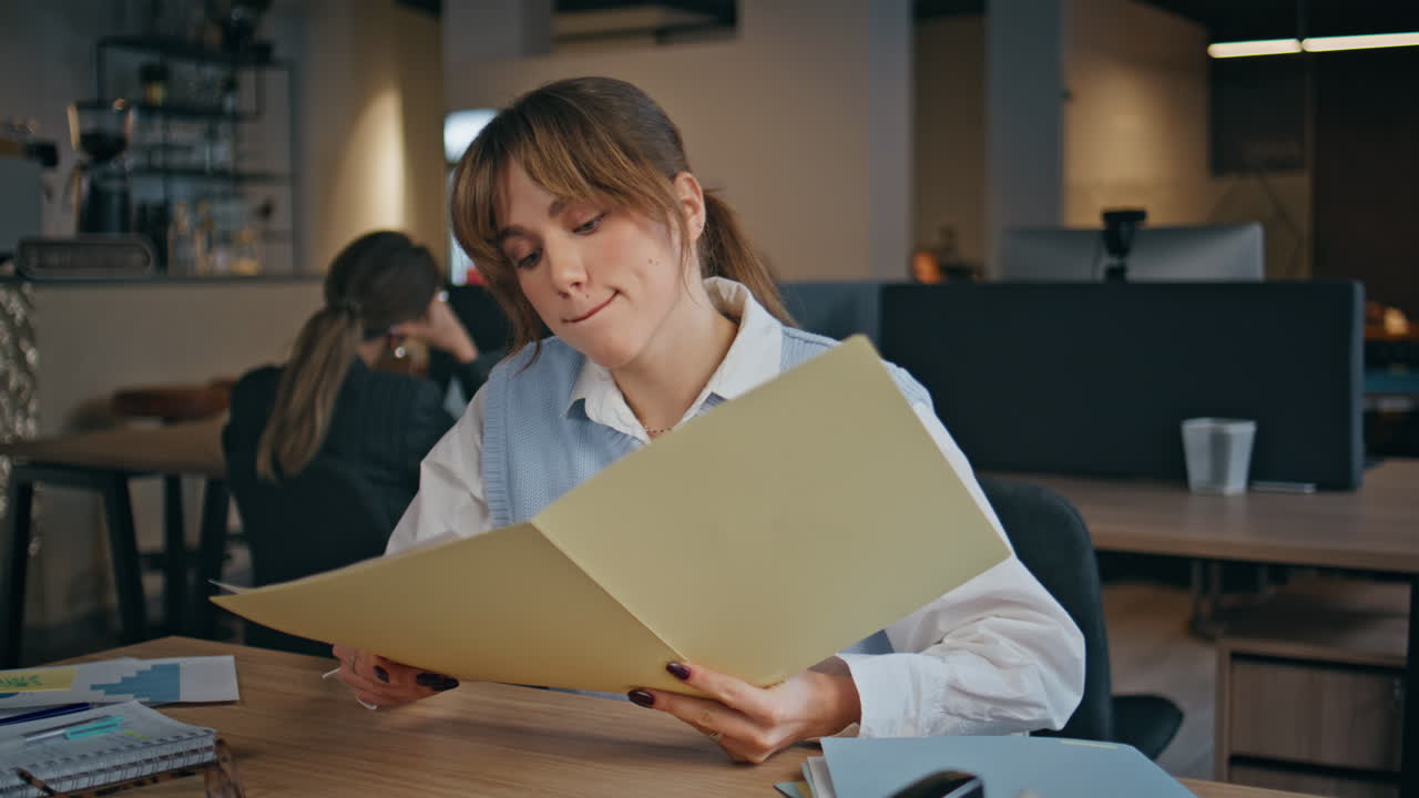 Young woman reading contracts sitting office closeup. Manager looking papers