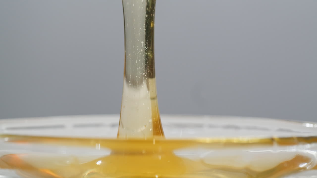 Tasty blue cheese with rosemary, honey and walnuts on white table, close up of Dorblu in cafe pouring in honey.