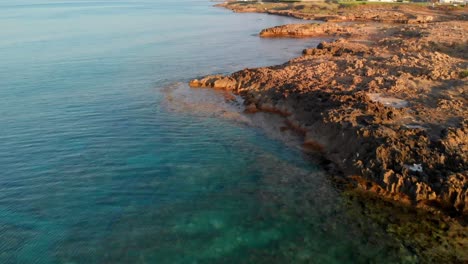 low angle view of rocky shore in cyprus, capturing rugged coastline and breaking waves