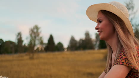 a girl in a dress riding a bike with flowers in a basket and laughing enjoying the freedom and summer air. slow motion.