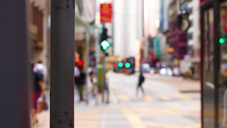 a red bus navigates a bustling city intersection