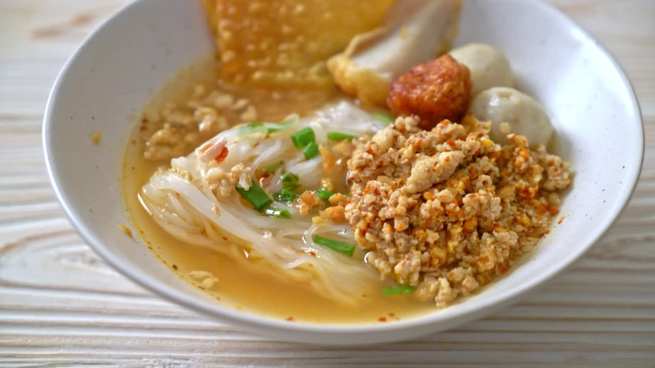 spicy noodles with fish ball and minced pork (Tom Yum Noodles) - Asian food style