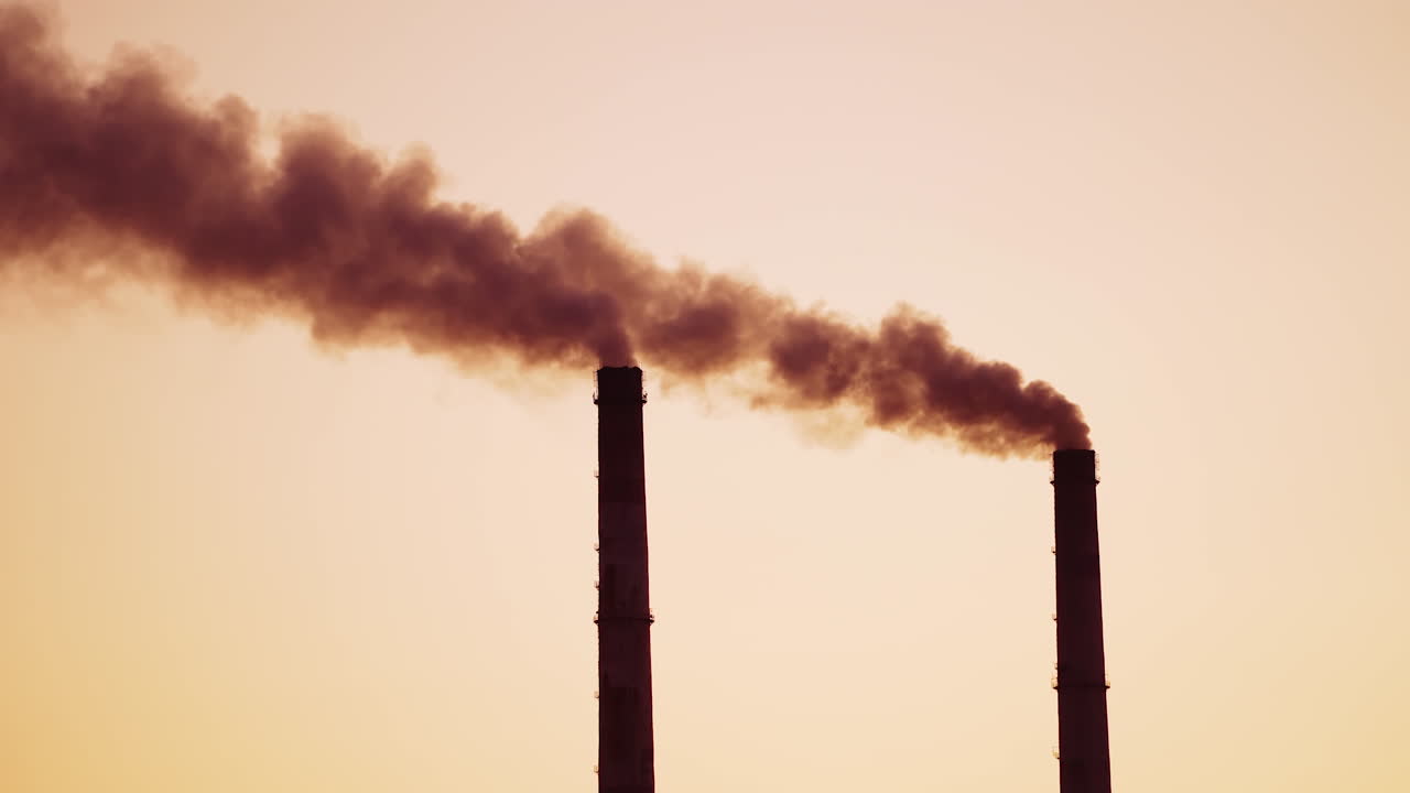 Chimney from polluting factory. Smoke of pipes pollutes atmosphere of the planet