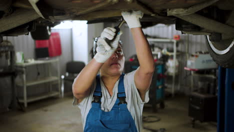 woman repairing car