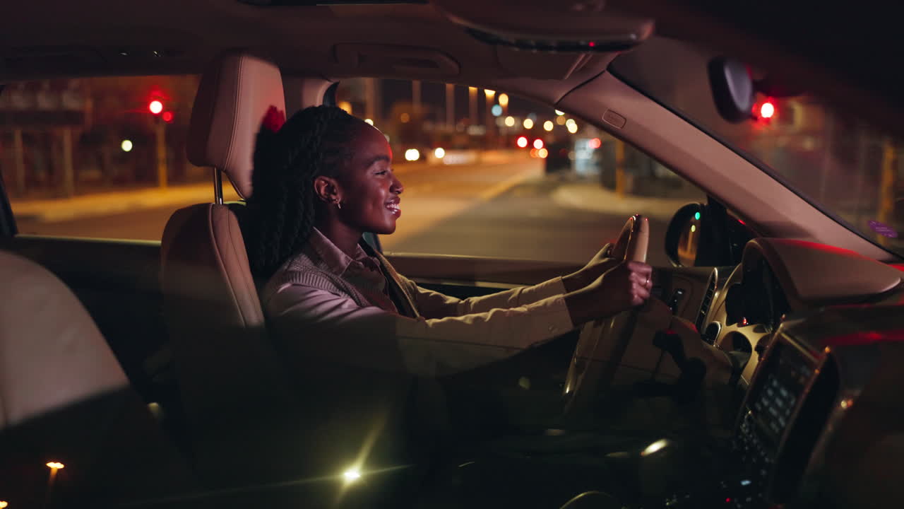 Woman driving car at night