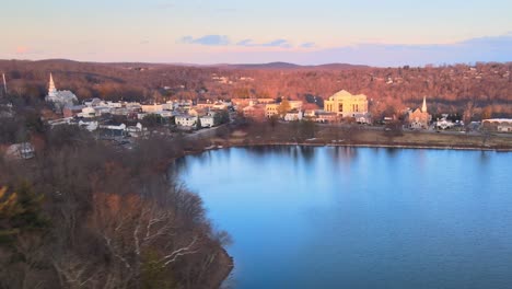 Drohnenaufnahmen-Aus-Der-Luft,-Die-Im-Winter-In-Amerika-Hinter-Kiefern-Und-über-Einer-Kleinen-Seestadt-Auftauchen