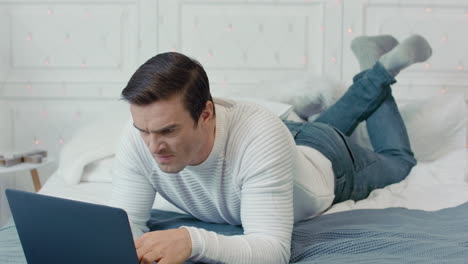 Concentrated business man getting negative news on computer at remote workplace.