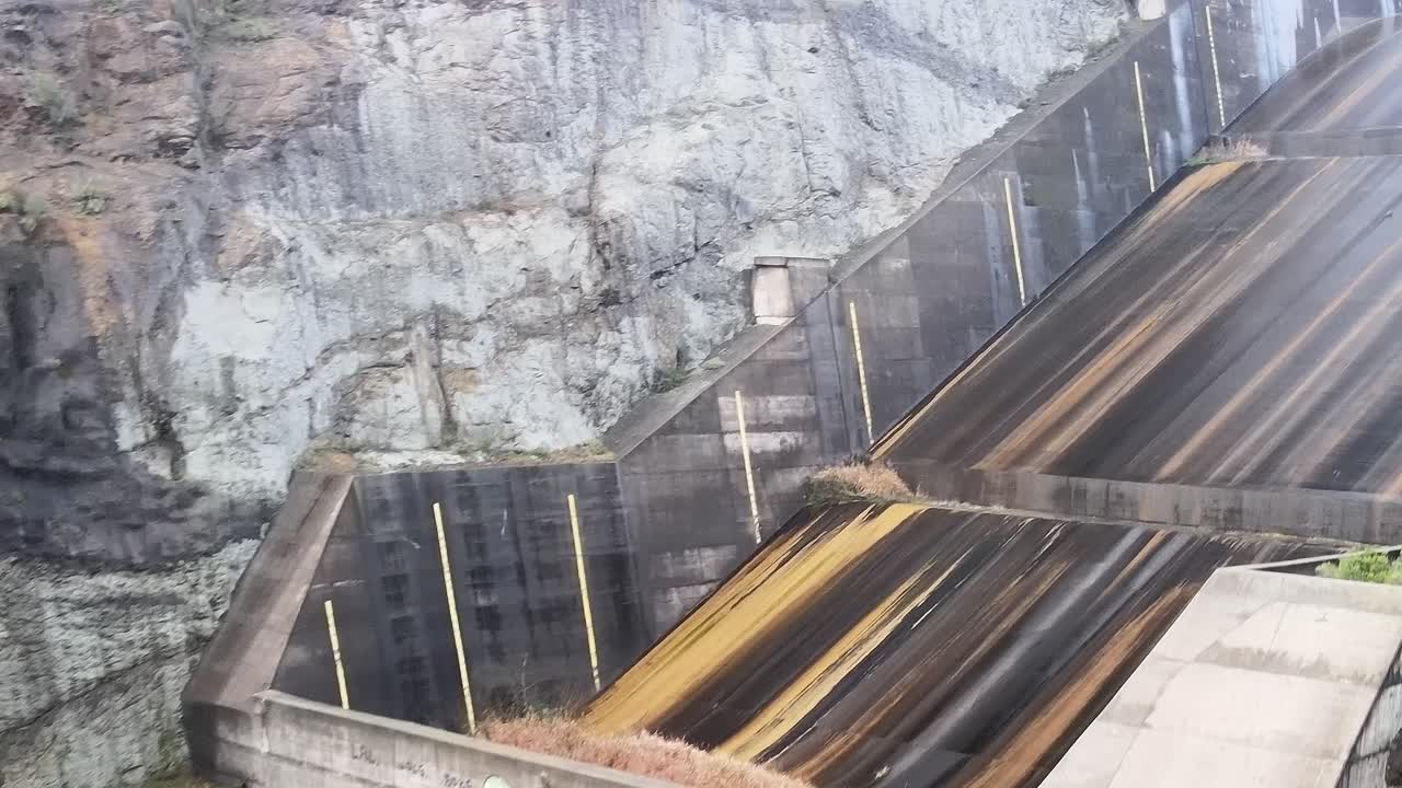 Visit to Colbun Lake in Chile showing the dam and surrounding rocks