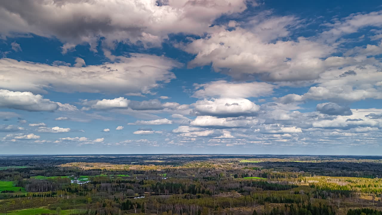 Dreamy cloudscape time lapse over a forest in Europe as seen from a high-altitude drone