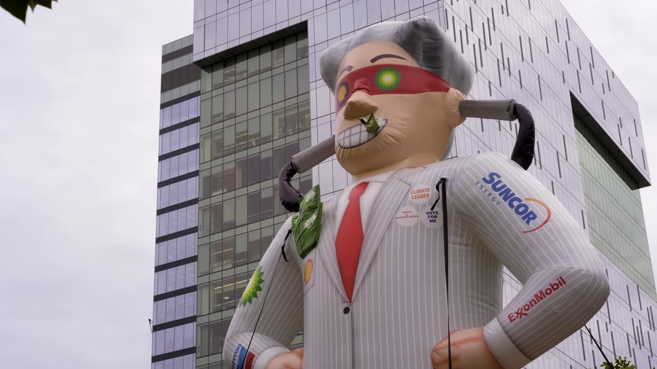 Blow Up Evil Capitalist CEO - Queens Park, Toronto, Canada - A huge human dummy displayed in the street nearby a commercial building - close up