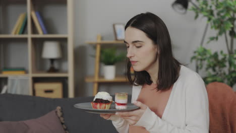 woman holding dessert in living room