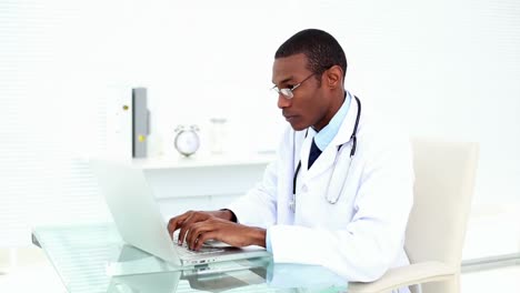 Concentrating-doctor-working-on-his-laptop