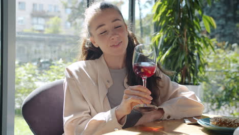 woman enjoying wine at a cafe