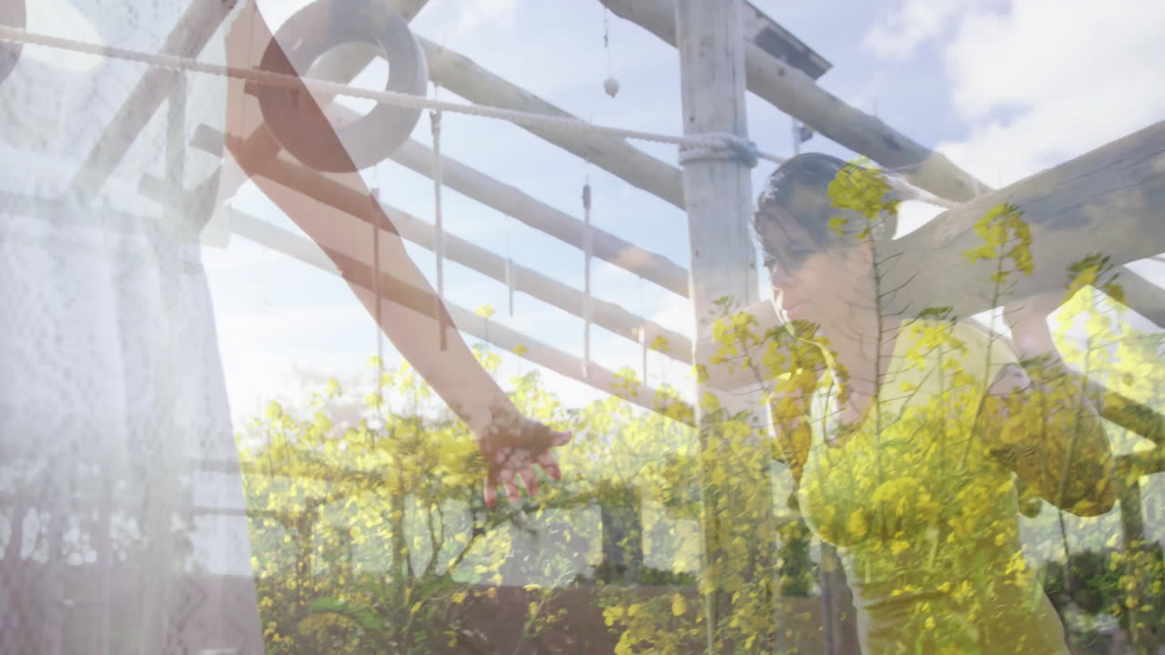Exercising on outdoor obstacle course, woman with animation of yellow flowers