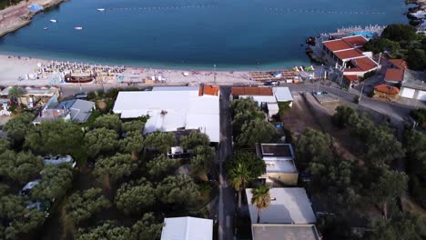 Flying-above-buildings-revealing-Utjeha-Beach-and-Adriatic-sea,-aerial