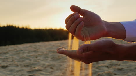 sands slip through the hands of man in a suit 1