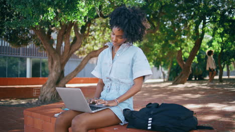 tired woman working laptop sitting green park.  freelancer looking screen