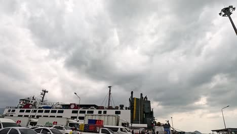 ferry arrives at pier under cloudy skies