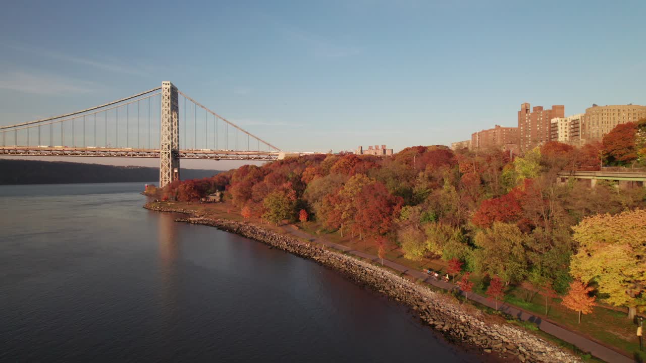 Cyclists in NYC's Riverside Park, gorgeous fall colors along the Hudson River
