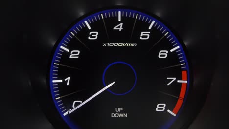 tachometer gauge of starting and stopping car close up