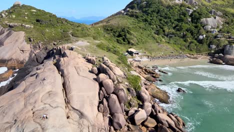 aerial drone view of deserted beach with many rocks and stones tropical paradise