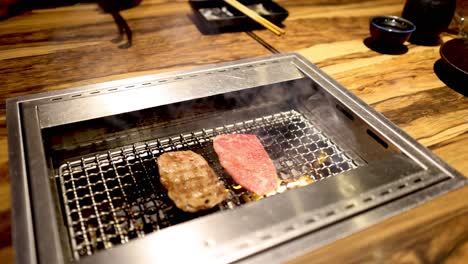 cooking meat slices on a grill indoors