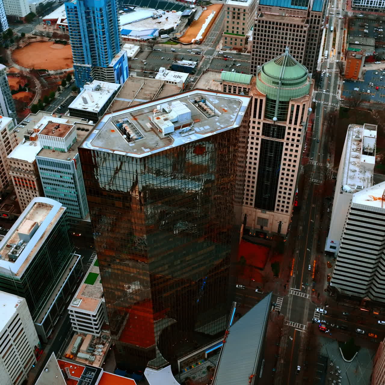 Flying around the high-rise building with mirror windows. City downtown of Charlotte, North Carolina, USA.