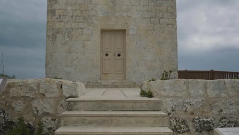 bottom-up panting shot of a lovely rural stone church on the countryside, malta