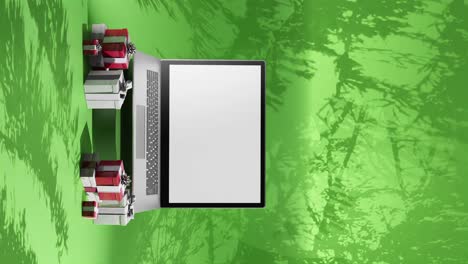 animación vertical de ventas de computadoras portátiles de navidad contra un fondo verde dinámico
