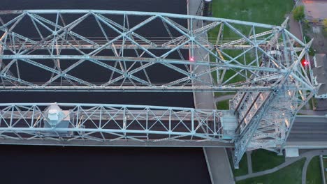 aerial overhead view lift bridge in down position over canal in duluth, minnesota off the shore of lake superior - drone high angle shot