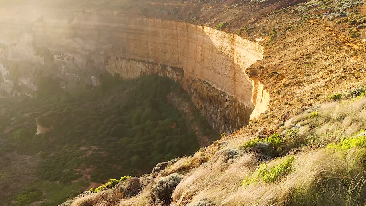 acantilados dorados y vegetación exuberante al atardecer