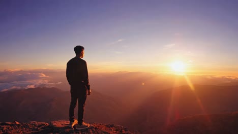 Man admiring sunrise over mountain landscape
