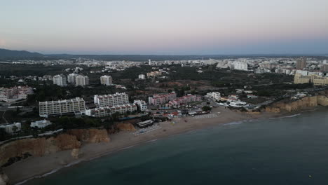 Sunset-Drone-Video-of-a-Beach-Resort-on-the-Coast-of-the-Algarve,-Portugal