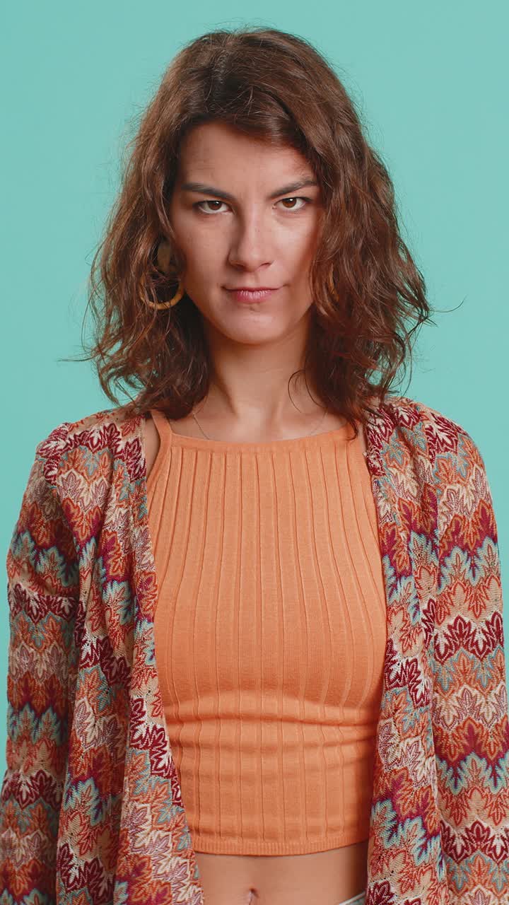 Upset attractive young woman lady showing thumbs down sign gesture disapproval dissatisfied dislike