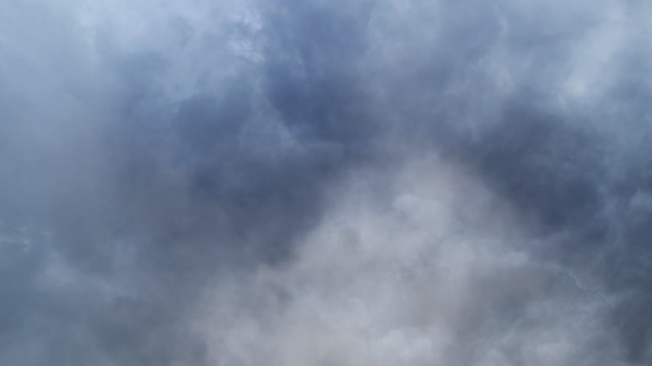 thunderstorm and dark gray clouds moving in the sky before it rains