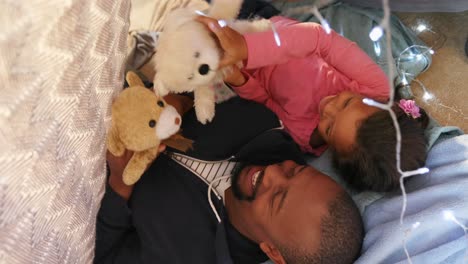 father and daughter playing with teddy bear in bedroom 4k