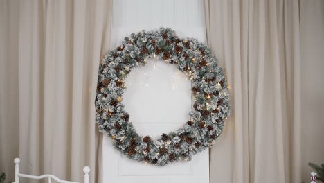 snowy pinecone wreath with twinkling lights